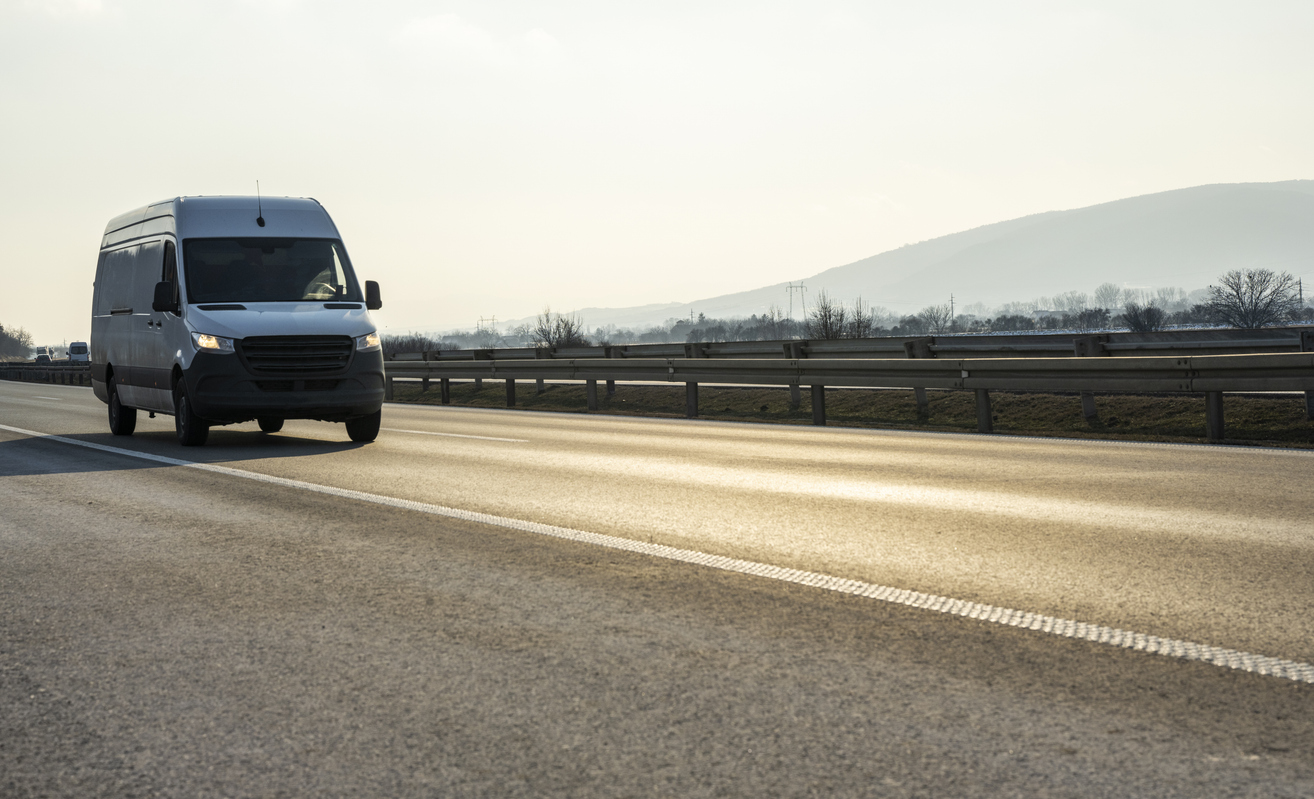 Distribution and logistics express service. Mini bus driving on highway day. banner